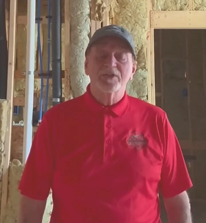 Stephen Selby in a red Renovation Defenders polo on a job site